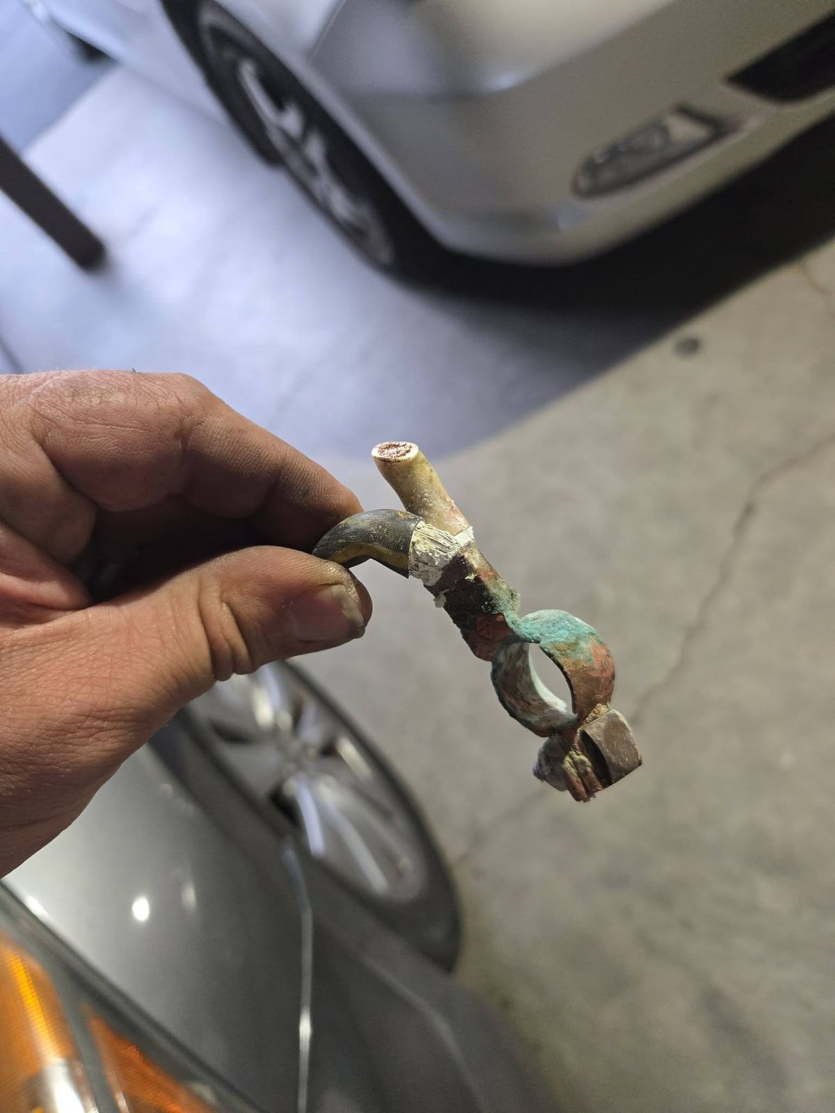 Badly corroded positive battery cable terminal removed from a 2012 Honda Accord in Ojai