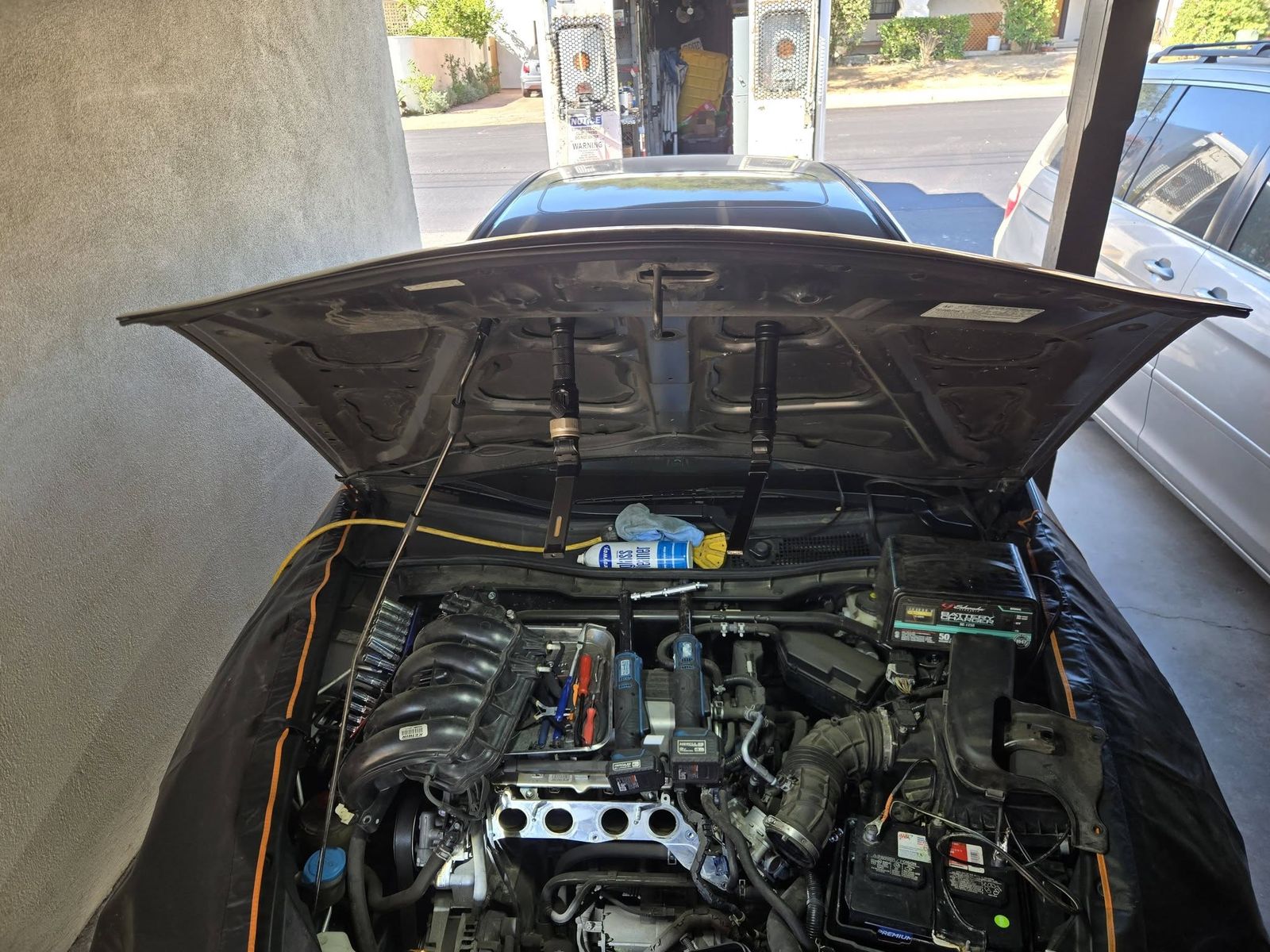 2012 Honda Accord in a carport with the hood up, fender covers on and the intake manifold removed during the starter job