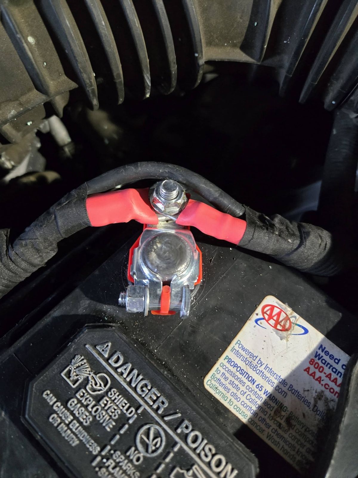 New positive battery terminal with red covers installed on a 2012 Honda Accord battery